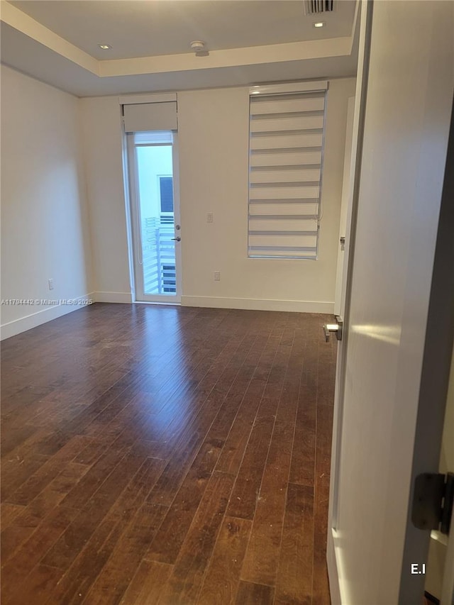 9133 NW 33rd St, Doral, FL 33172 - empty room featuring dark wood-style floors, a tray ceiling, and baseboards