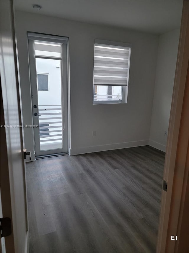 9133 NW 33rd St, Doral, FL 33172 - empty room with a smoke detector, dark wood-type flooring, and baseboards