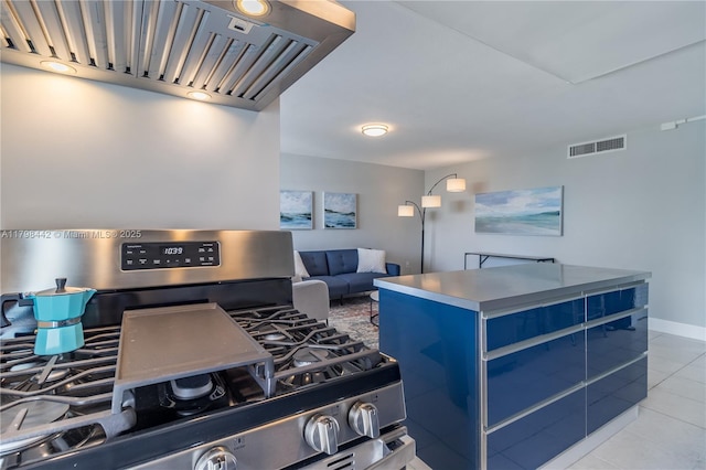 301 Jefferson Ave Unit 4D, Miami Beach, FL 33139 - kitchen with stainless steel range with gas cooktop, range hood, tile patterned floors, a center island, and blue cabinetry