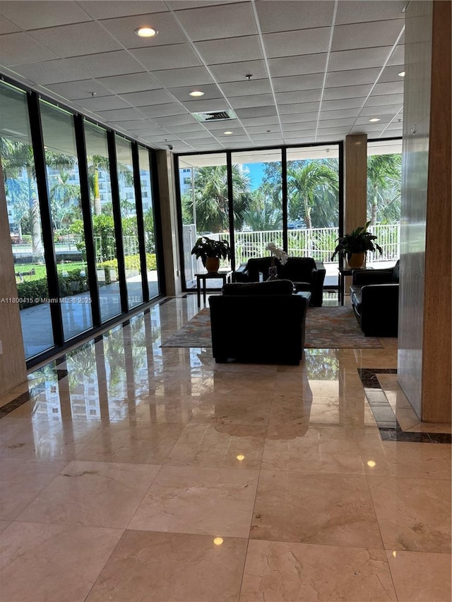 400 Kings Point Dr Unit 309, Sunny Isles Beach, FL 33160 - lobby featuring a wall of windows and a drop ceiling