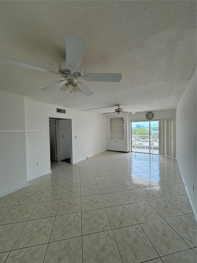 400 Kings Point Dr Unit 309, Sunny Isles Beach, FL 33160 - empty room featuring a textured ceiling, light tile patterned flooring, and a ceiling fan
