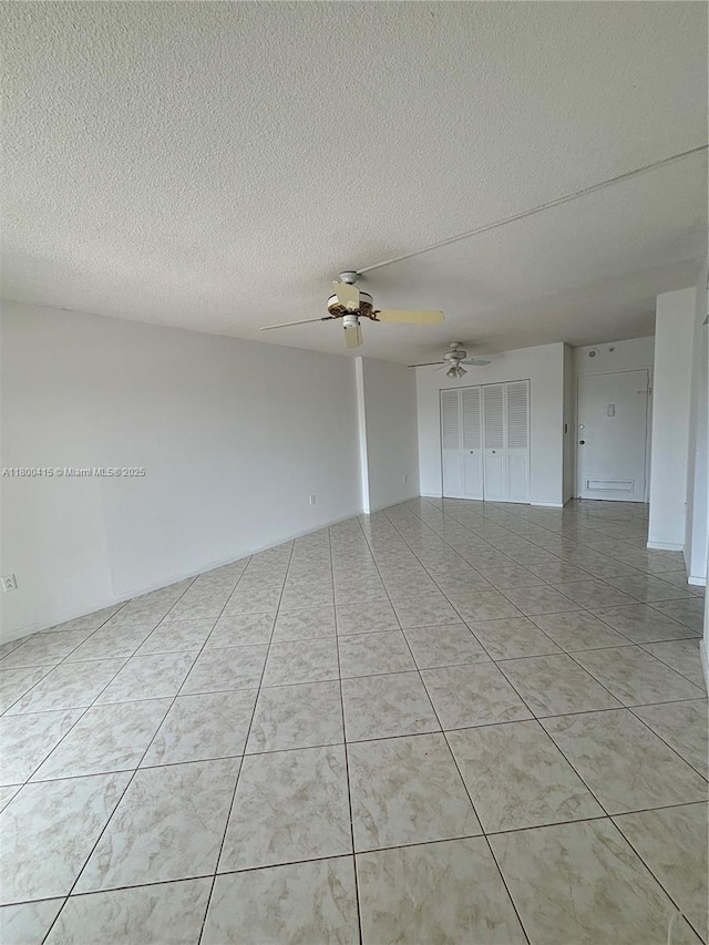 400 Kings Point Dr Unit 309, Sunny Isles Beach, FL 33160 - spare room with a ceiling fan, a textured ceiling, and light tile patterned floors