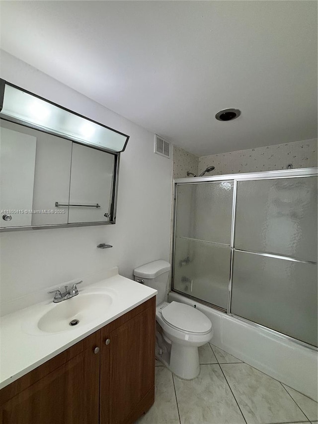 400 Kings Point Dr Unit 309, Sunny Isles Beach, FL 33160 - full bath with vanity, toilet, tile patterned flooring, and combined bath / shower with glass door