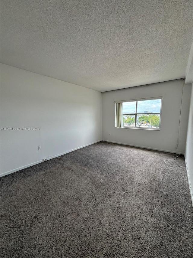 400 Kings Point Dr Unit 309, Sunny Isles Beach, FL 33160 - carpeted spare room featuring a textured ceiling and baseboards