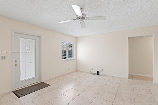 unfurnished room featuring a textured ceiling, a ceiling fan, and light tile patterned flooring