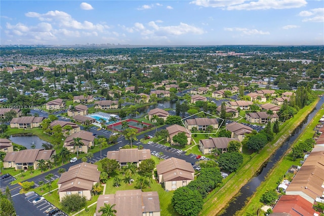 aerial view of residential area featuring a large body of water