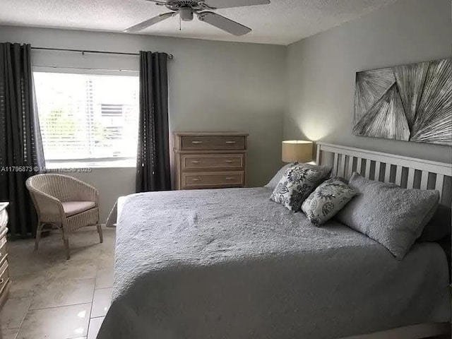 322 Pine Ridge Cir Unit A-2, Green Acres, FL 33463 - bedroom with a textured ceiling, light tile patterned floors, and ceiling fan
