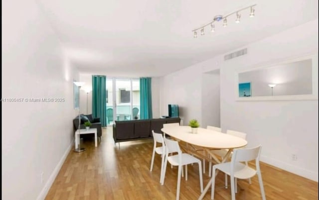 3901 S Ocean Dr Unit 2Z, Hollywood, FL 33019 - dining room with light wood-style floors and baseboards
