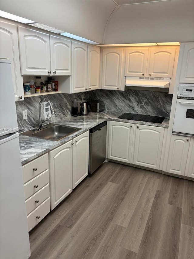 3901 S Ocean Dr Unit 2Z, Hollywood, FL 33019 - kitchen with white appliances, a sink, dark wood-style flooring, under cabinet range hood, and white cabinets