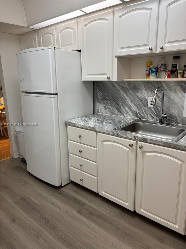 3901 S Ocean Dr Unit 2Z, Hollywood, FL 33019 - kitchen with a sink, freestanding refrigerator, wood finished floors, and white cabinetry