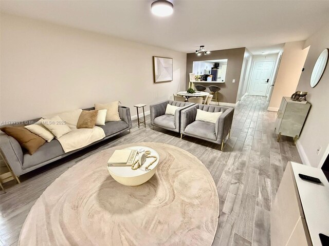 300 Promenade Dr Unit 105, Dunedin, FL 34698 - living room featuring wood finished floors and baseboards