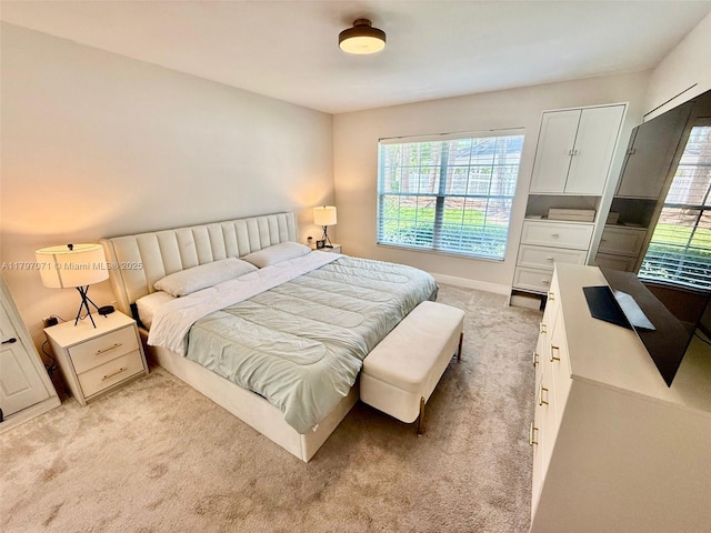 300 Promenade Dr Unit 105, Dunedin, FL 34698 - bedroom featuring light carpet, multiple windows, and baseboards