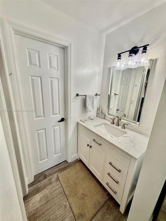 300 Promenade Dr Unit 105, Dunedin, FL 34698 - bathroom featuring wood finished floors and vanity