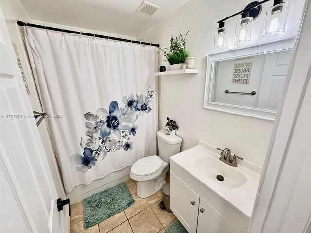 300 Promenade Dr Unit 105, Dunedin, FL 34698 - bathroom with toilet, vanity, and tile patterned floors