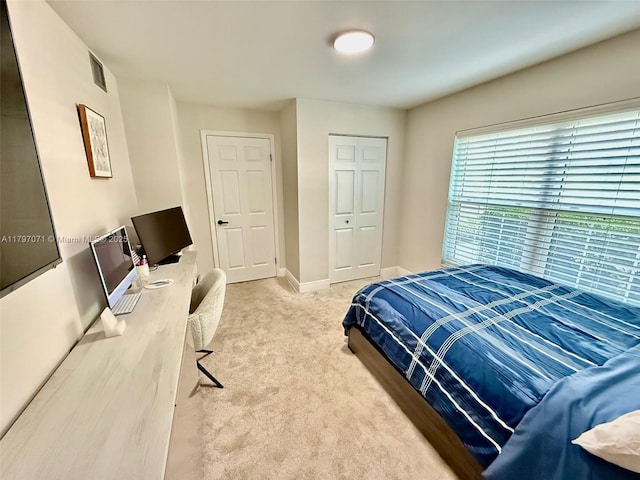 300 Promenade Dr Unit 105, Dunedin, FL 34698 - bedroom featuring carpet floors, a closet, baseboards, and an office area