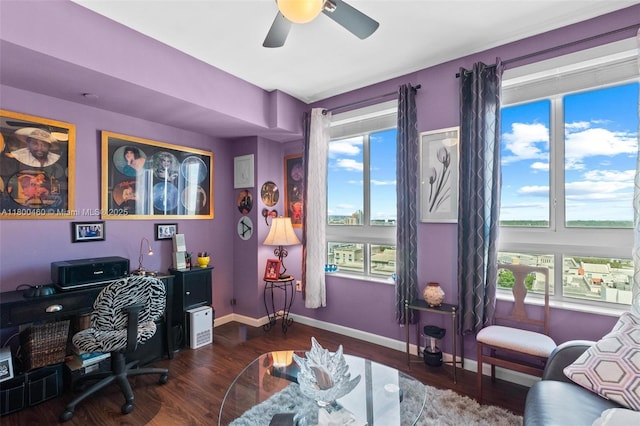 home office with wood finished floors, a ceiling fan, and baseboards