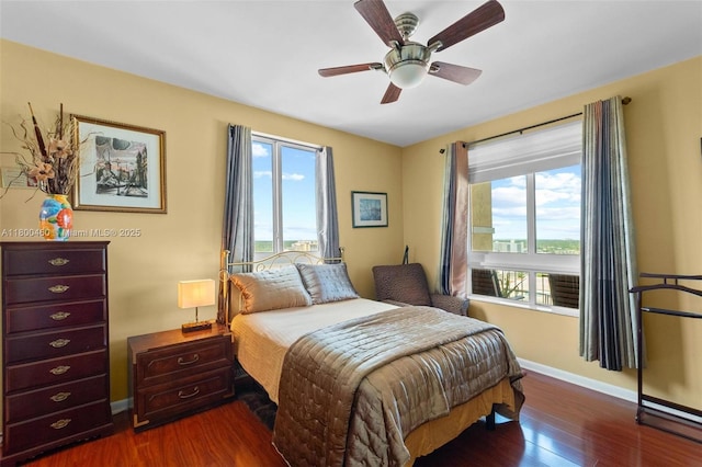 bedroom featuring baseboards, dark wood-style flooring, and ceiling fan