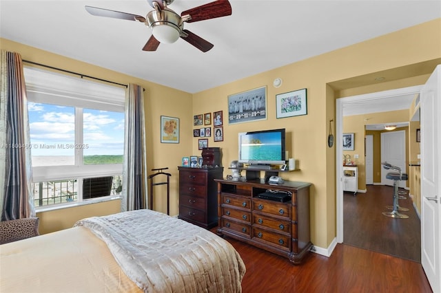 bedroom with dark wood finished floors, baseboards, and a ceiling fan