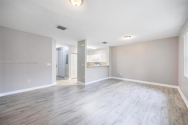 2933 SE 2nd St Unit 20, Homestead, FL 33033 - unfurnished living room with light wood-style flooring and baseboards
