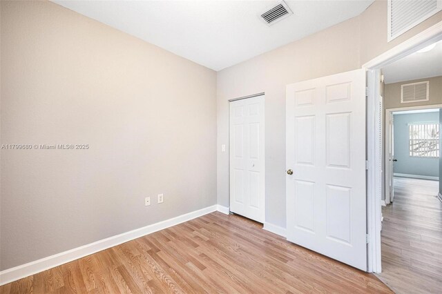2933 SE 2nd St Unit 20, Homestead, FL 33033 - unfurnished bedroom featuring baseboards, light wood finished floors, and a closet