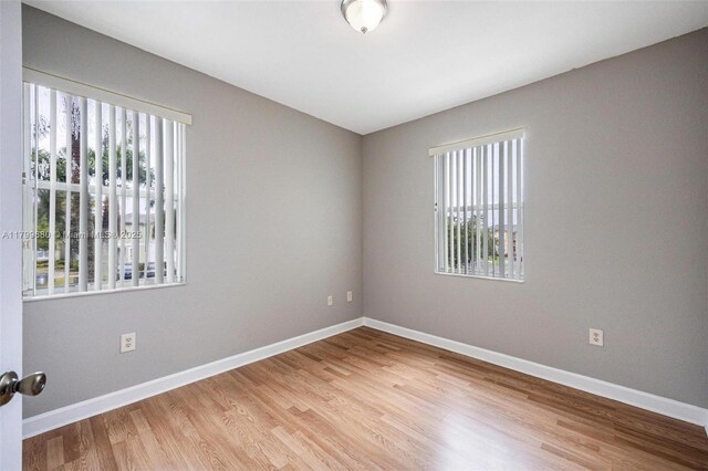 2933 SE 2nd St Unit 20, Homestead, FL 33033 - spare room featuring plenty of natural light, wood finished floors, and baseboards