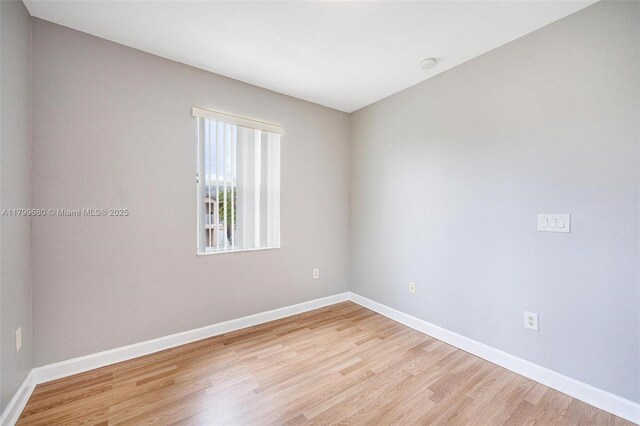 2933 SE 2nd St Unit 20, Homestead, FL 33033 - empty room with light wood finished floors, baseboards, and a smoke detector