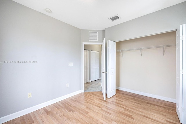 2933 SE 2nd St Unit 20, Homestead, FL 33033 - unfurnished bedroom with light wood-style floors, a closet, and baseboards