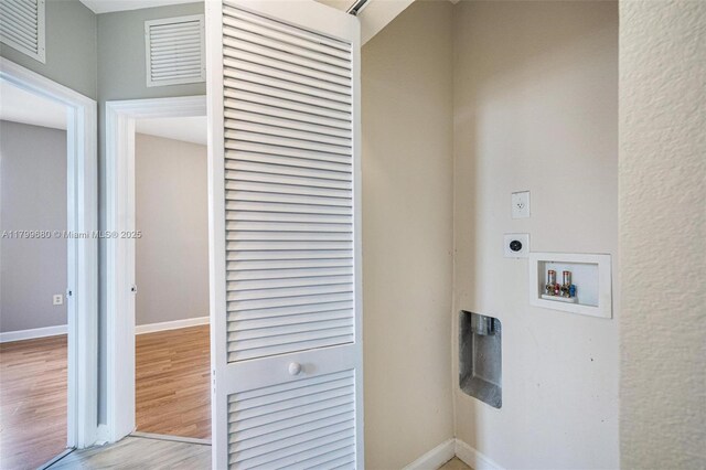 2933 SE 2nd St Unit 20, Homestead, FL 33033 - washroom with hookup for an electric dryer, hookup for a washing machine, light wood-style flooring, and baseboards