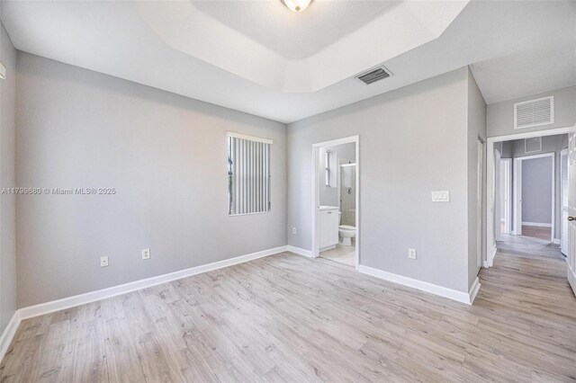 2933 SE 2nd St Unit 20, Homestead, FL 33033 - unfurnished room featuring light wood-type flooring, baseboards, and a raised ceiling