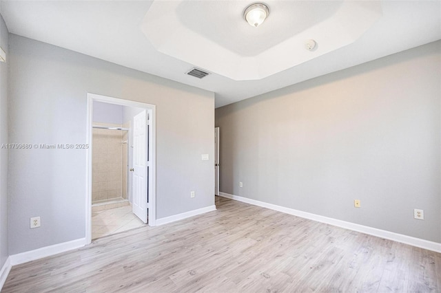 2933 SE 2nd St Unit 20, Homestead, FL 33033 - unfurnished bedroom featuring light wood-style floors, baseboards, and ensuite bathroom