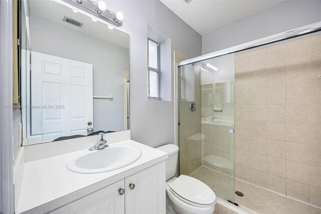 2933 SE 2nd St Unit 20, Homestead, FL 33033 - bathroom featuring toilet, a stall shower, and vanity