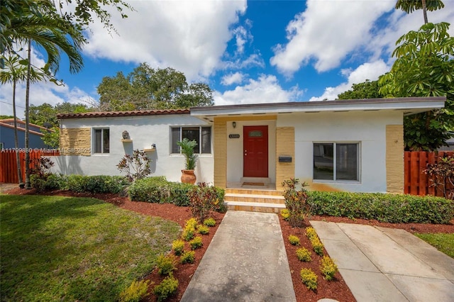 12000 NE 11th Ct, Biscayne Park, FL 33161 - view of front of home with stucco siding and a tiled roof