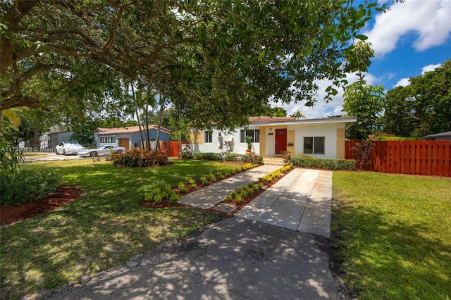 12000 NE 11th Ct, Biscayne Park, FL 33161 - view of front of home featuring stucco siding and concrete driveway