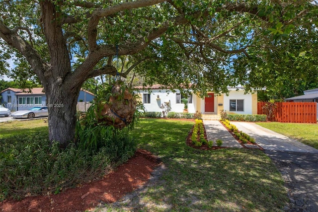 12000 NE 11th Ct, Biscayne Park, FL 33161 - view of property hidden behind natural elements featuring stucco siding and driveway
