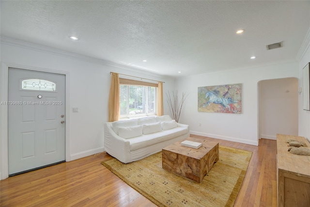 12000 NE 11th Ct, Biscayne Park, FL 33161 - living area with crown molding, light wood-style floors, baseboards, recessed lighting, and a textured ceiling