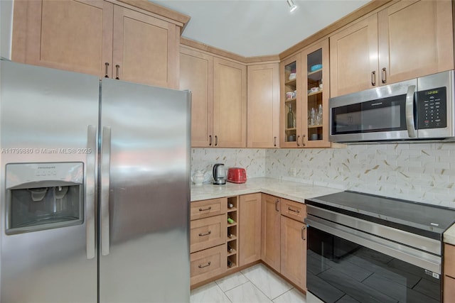 12000 NE 11th Ct, Biscayne Park, FL 33161 - kitchen with stainless steel appliances, light stone countertops, glass insert cabinets, and backsplash