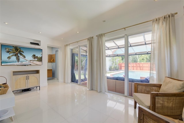 12000 NE 11th Ct, Biscayne Park, FL 33161 - living area with light tile patterned flooring, healthy amount of natural light, a sunroom, and recessed lighting