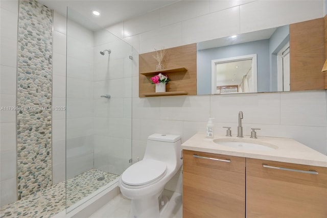 12000 NE 11th Ct, Biscayne Park, FL 33161 - bathroom featuring toilet, tiled shower, tile walls, vanity, and backsplash