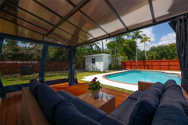 12000 NE 11th Ct, Biscayne Park, FL 33161 - view of swimming pool featuring a storage unit, outdoor lounge area, an outbuilding, and a wooden deck