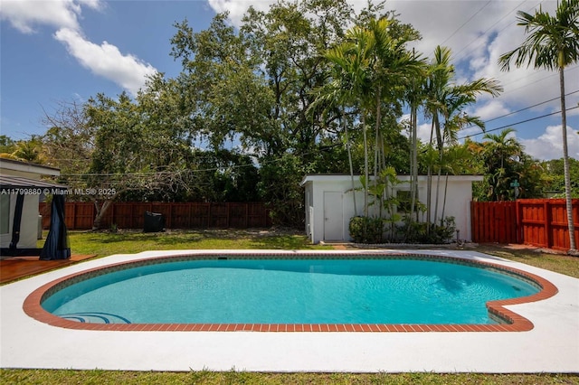 12000 NE 11th Ct, Biscayne Park, FL 33161 - view of swimming pool with a shed, an outdoor structure, and a fenced backyard