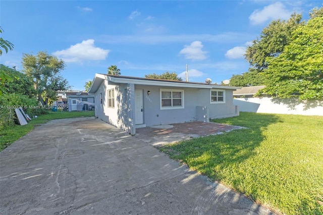 3051 NW 77th St, Miami, FL 33147 - view of front of house featuring stucco siding and a patio