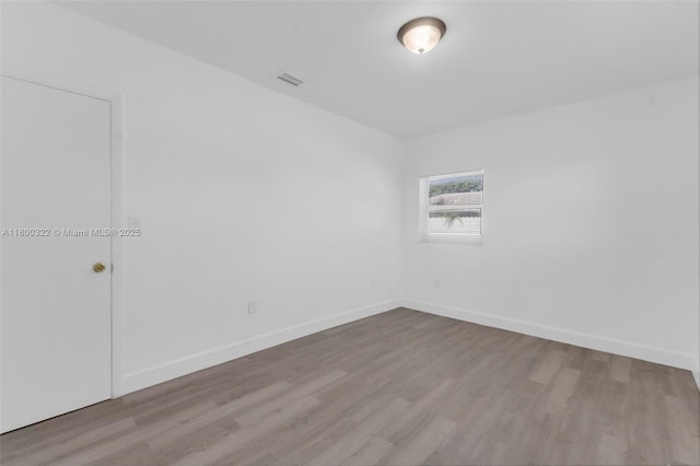 3051 NW 77th St, Miami, FL 33147 - unfurnished room with wood finished floors and baseboards