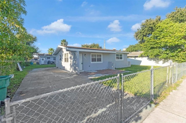 3051 NW 77th St, Miami, FL 33147 - view of front of property featuring stucco siding and asphalt driveway