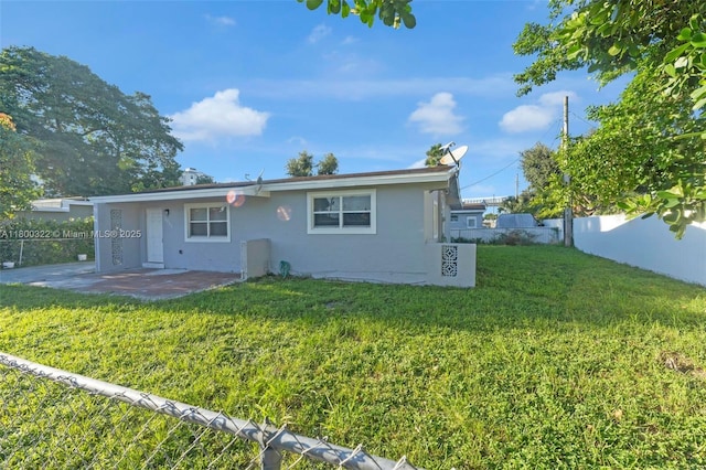 3051 NW 77th St, Miami, FL 33147 - back of house featuring stucco siding and a patio