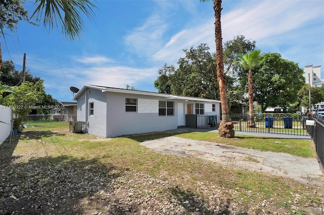 3051 NW 77th St, Miami, FL 33147 - view of front of property featuring stucco siding and central AC unit