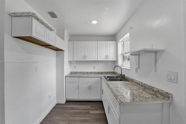 3051 NW 77th St, Miami, FL 33147 - kitchen with a sink, white cabinets, dark wood-style floors, baseboards, and recessed lighting