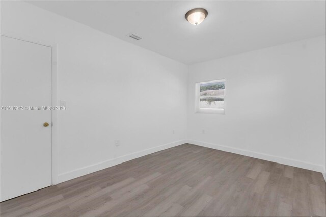 3051 NW 77th St, Miami, FL 33147 - unfurnished room with wood finished floors and baseboards