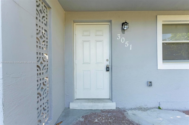 3051 NW 77th St, Miami, FL 33147 - doorway to property with stucco siding