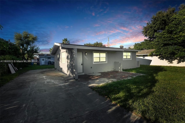 3051 NW 77th St, Miami, FL 33147 - back of house at dusk with stucco siding and a patio