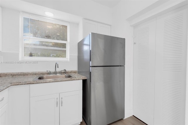 3051 NW 77th St, Miami, FL 33147 - kitchen featuring freestanding refrigerator, a sink, and white cabinetry